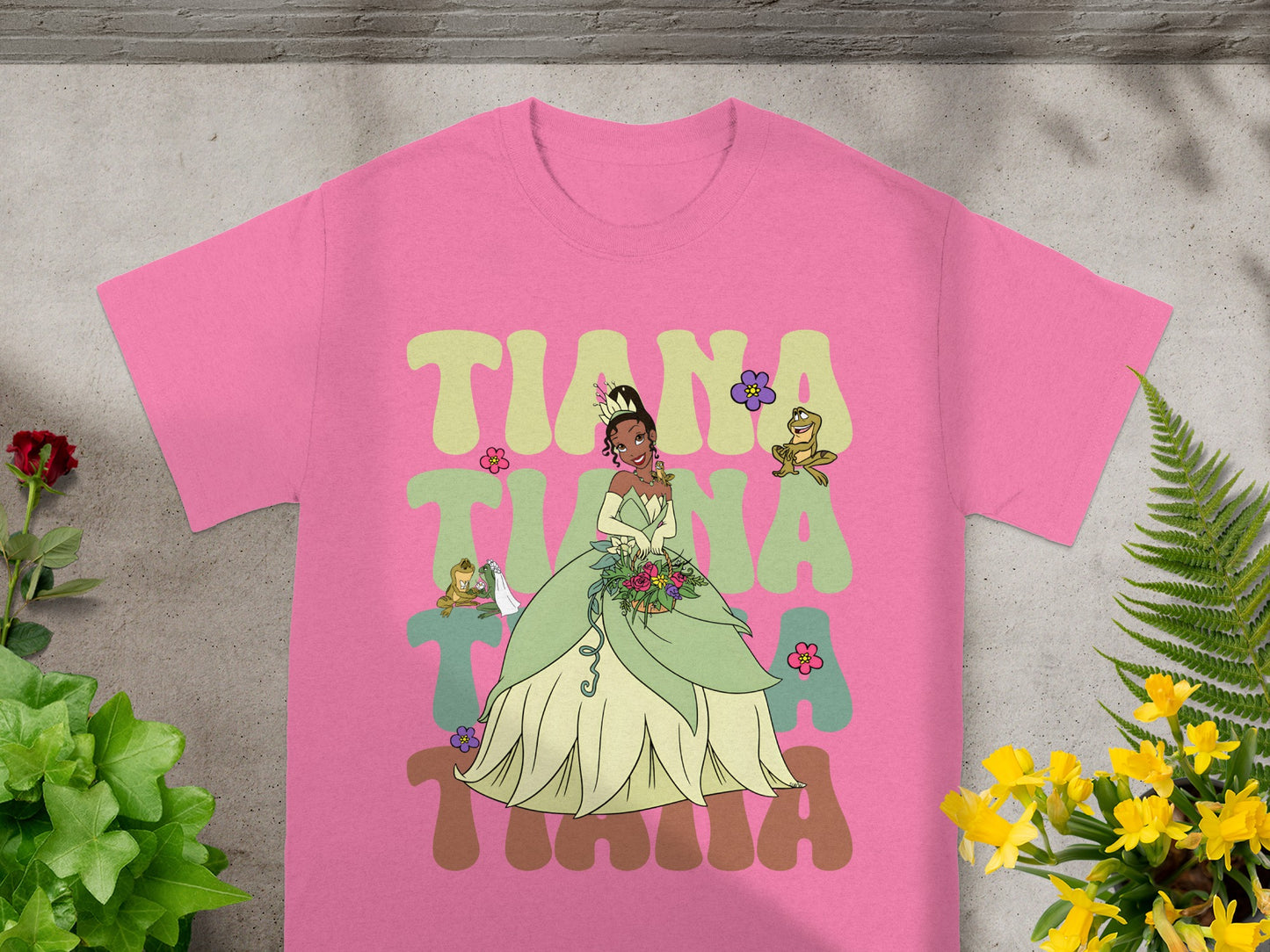 Pink t-shirt with Princess Tiana graphic and floral accents.