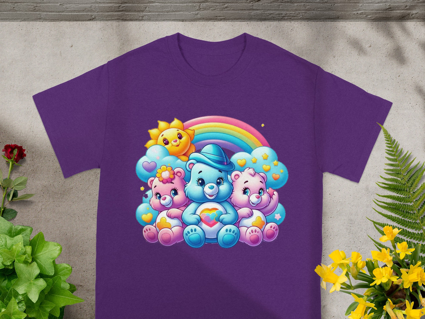 Three Care Bears characters sitting together under a rainbow on a purple t-shirt.