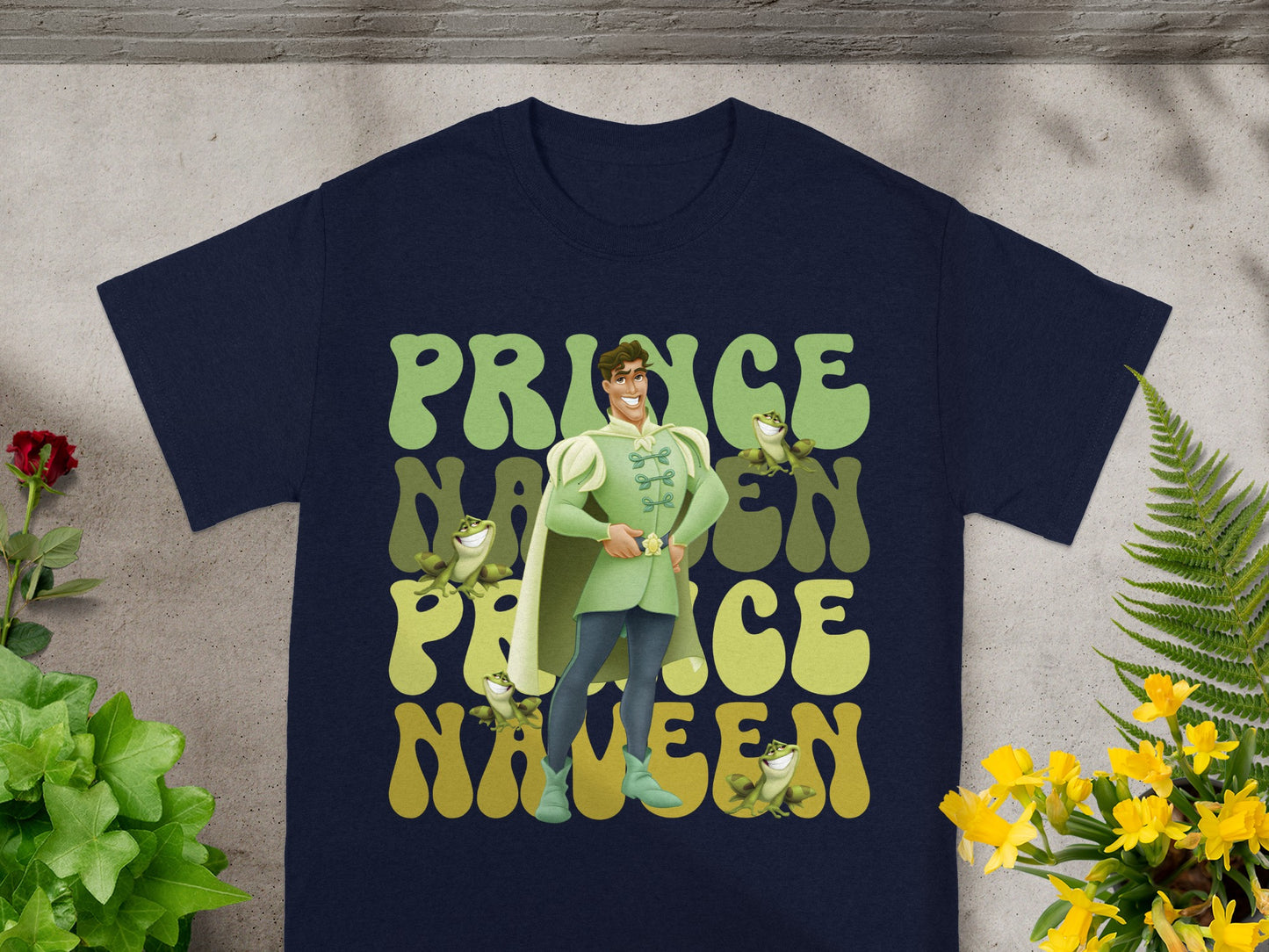T-shirt with cartoon Prince Naveen and frogs, "Prince Naveen" text.