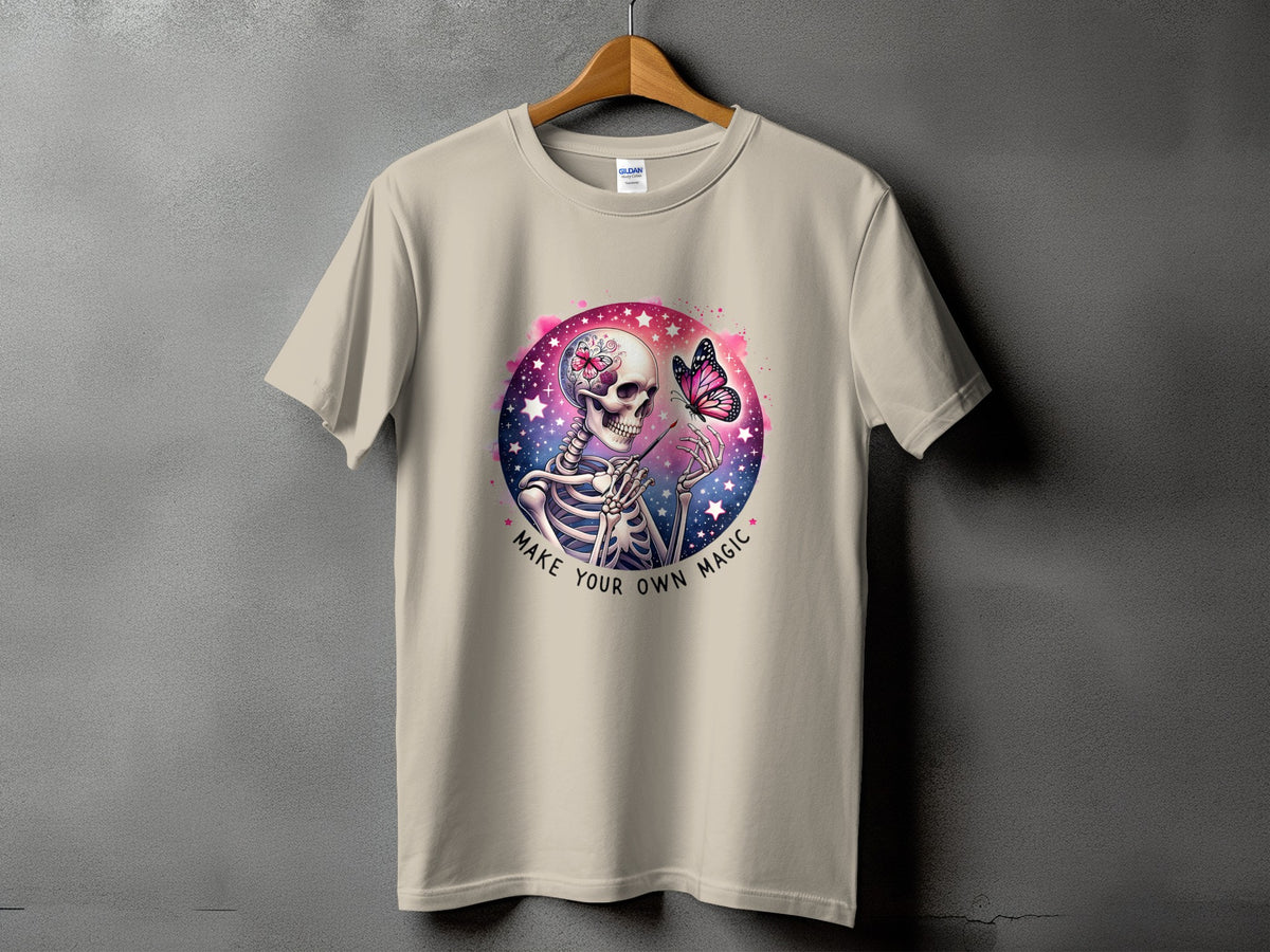 Skeleton with butterfly on shirt, text "MAKE YOUR OWN MAGIC".