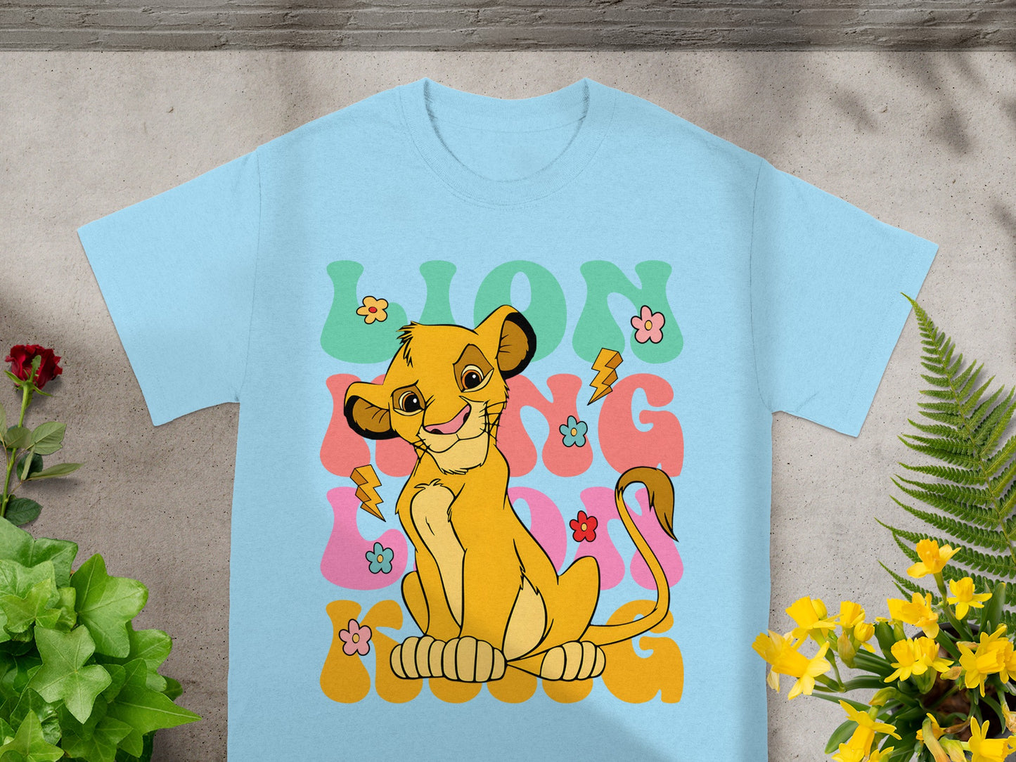Light blue t-shirt with Simba from The Lion King graphic.