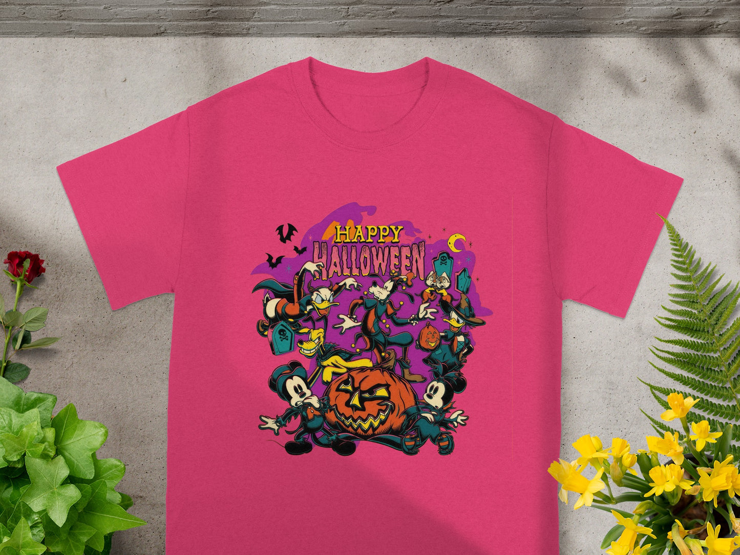 Pink t-shirt with cartoon characters and "Happy Halloween" text around a pumpkin.
