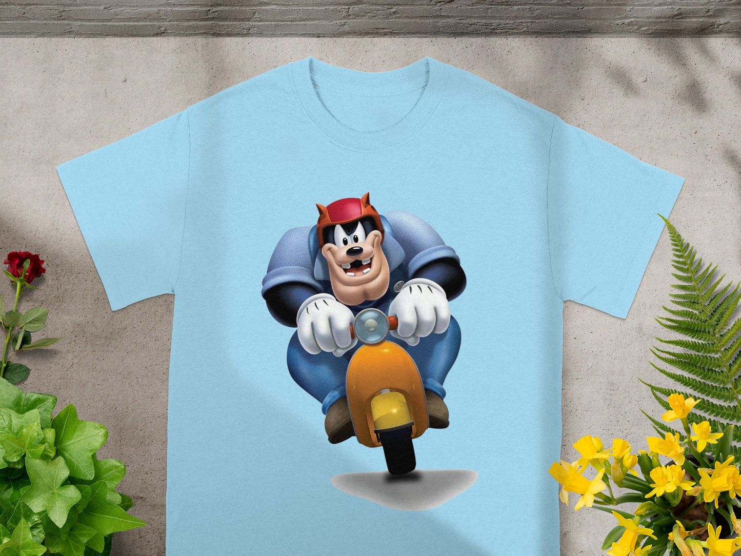 Blue t-shirt with cartoon character Pete riding a scooter.