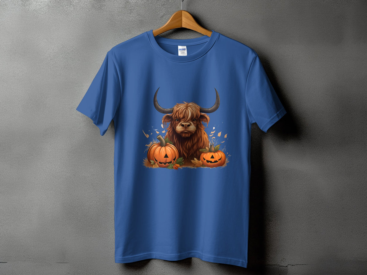 Highland cow with pumpkins graphic on a blue t-shirt.