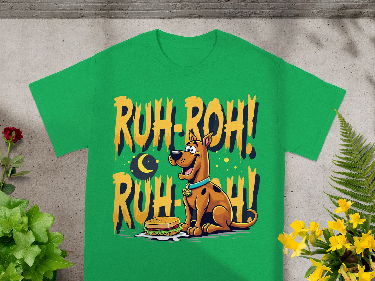 Scooby-Doo sits by a sandwich with "Ruh-Roh!" text on green shirt.