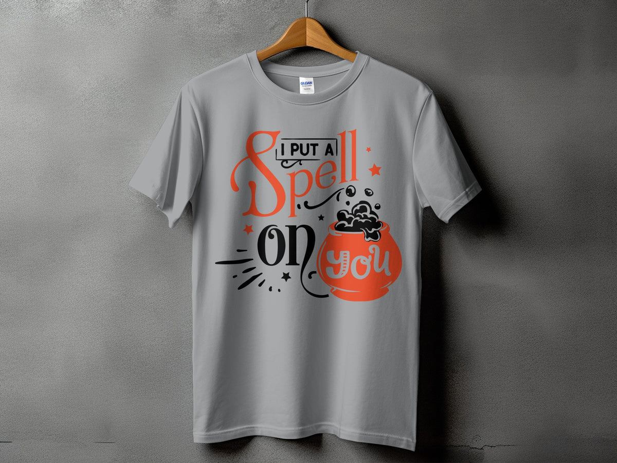 Grey t-shirt with "I put a spell on you" text and cauldron graphic.