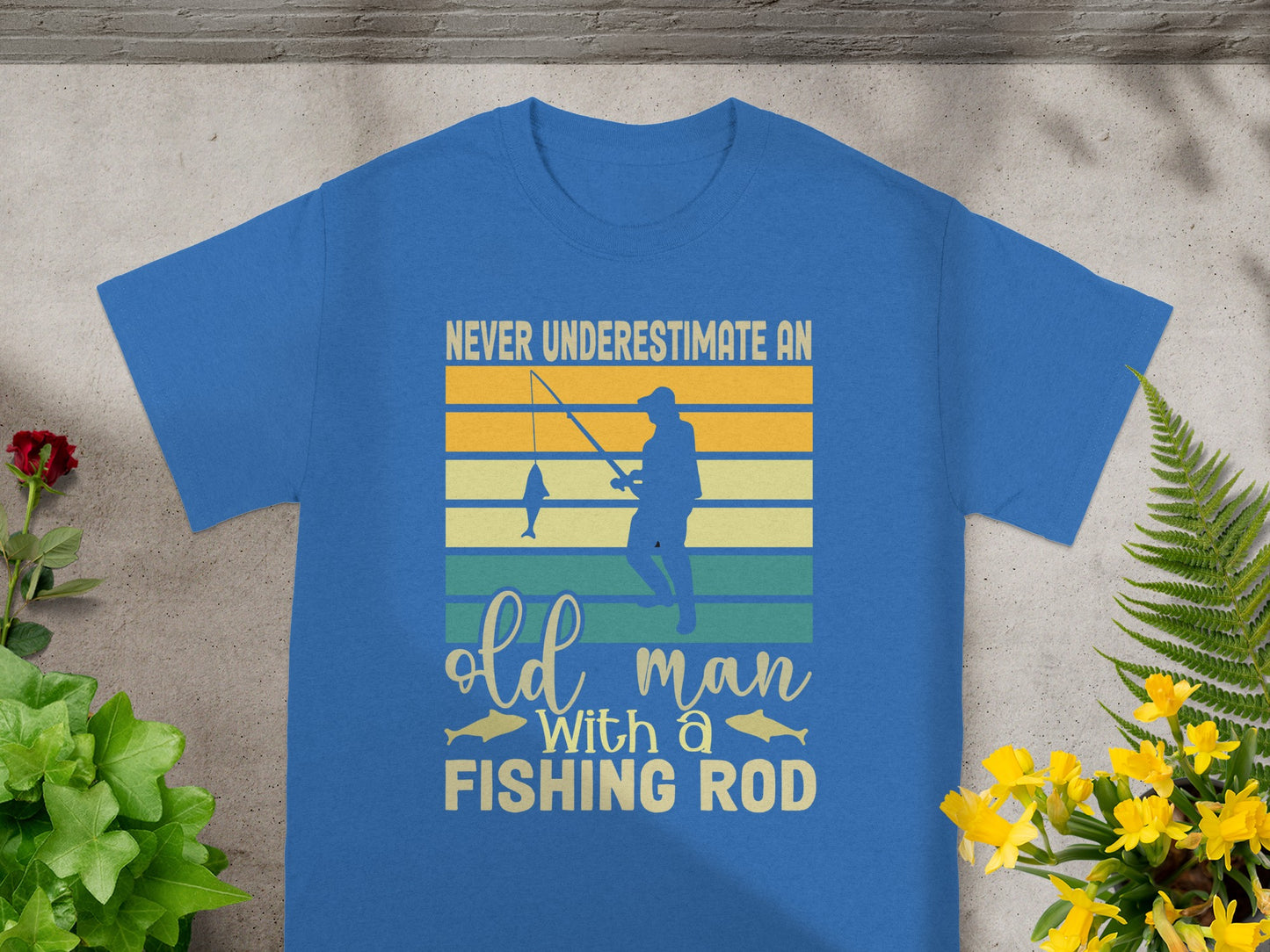 Blue t-shirt with text "Never underestimate an old man with a fishing rod" and graphic.