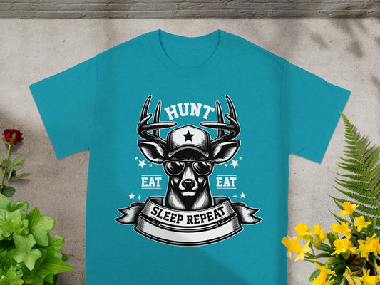 Teal t-shirt with a deer wearing a hat and sunglasses, featuring "HUNT," "EAT," and "SLEEP REPEAT."
