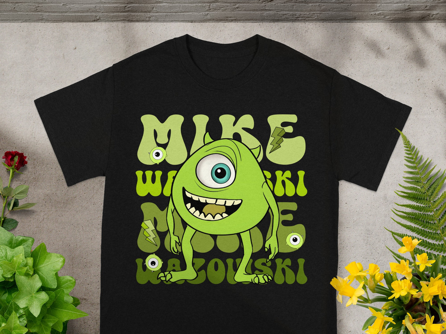 Mike Wazowski character graphic with text on a black t-shirt.
