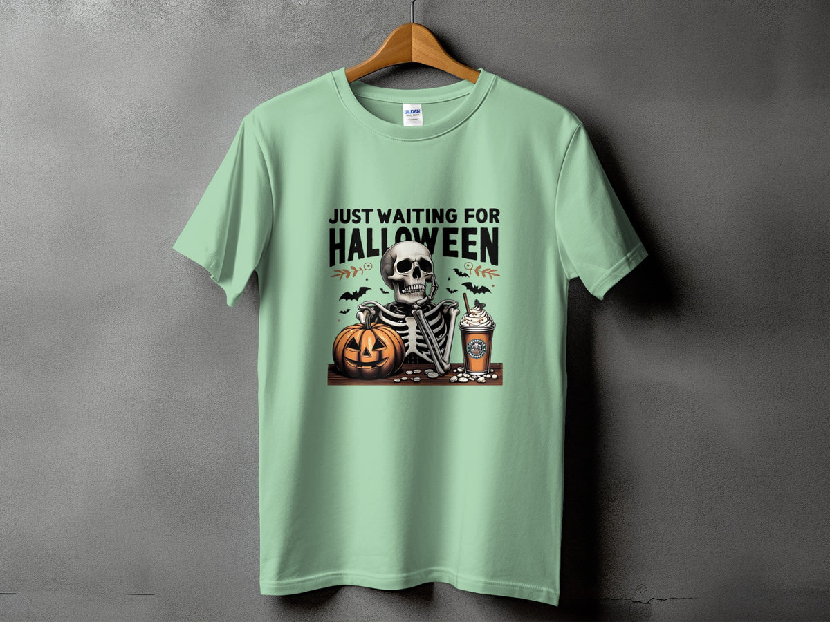 Light green t-shirt with skeleton, pumpkin, and coffee cup Halloween graphic and text.